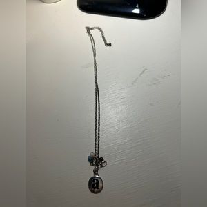 Ladies or girls 16” silver necklace with 3” extender. Has a hanging letter a.